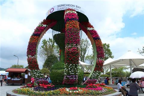 A colorful statue made with real flowers.