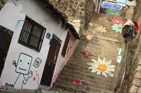 Colorful daisies welcome visitors in this village...